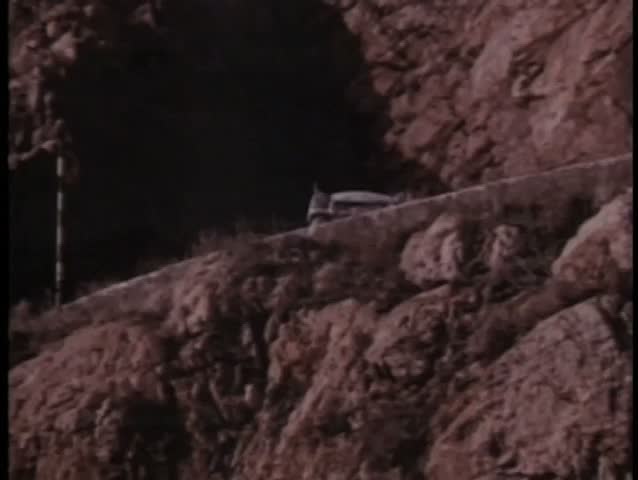 Slow motion car falling off cliff into water