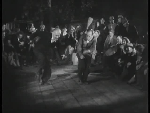 Crowd watching people dancing outdoors