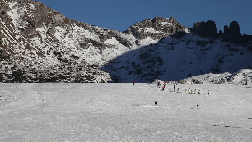 People skiing on a wide track