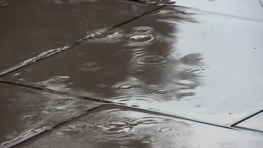Rain landing in puddle