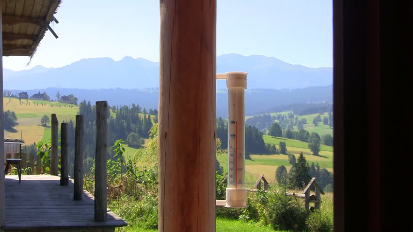 Thermometer on a porch with Mountain View shows hot summer temperature
