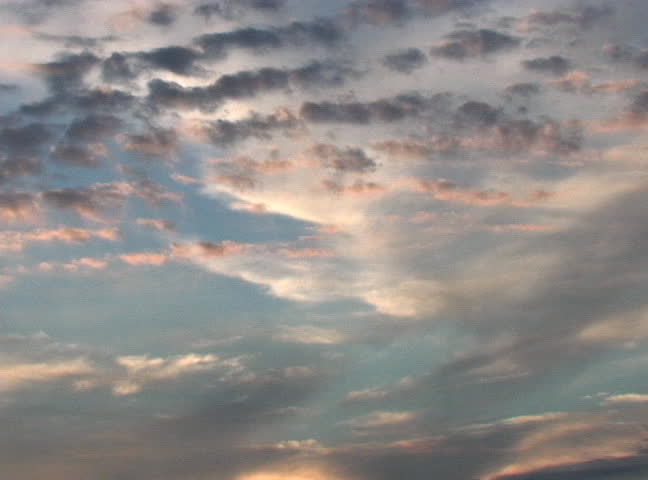 The sun sets and creates beautiful colors in the clouds.