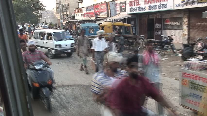 JALANDHAR, INDIA - AUGUST 20, 2006: Street ambiance viewed from a bus