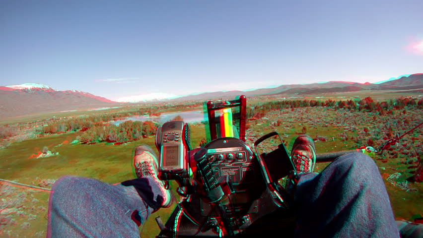 3D stereoscopic anaglyph aerial flying an ultralight aircraft from view of the pilot during flight over rural farming pond or lake.
