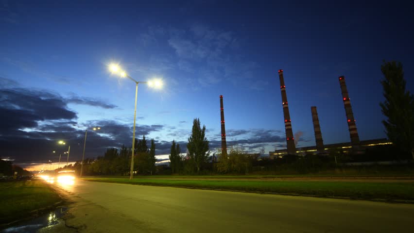 Cars go on highway in front of chimney shaft of manufacturing plant AUTOVAZ, time lapse