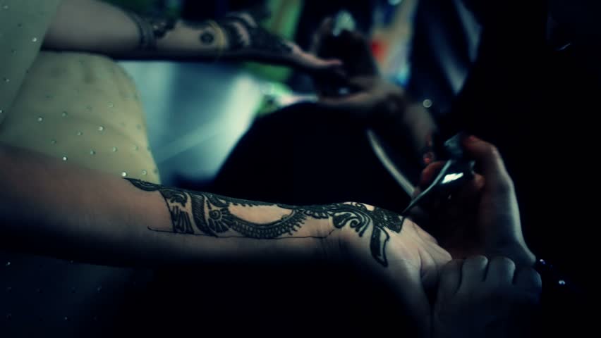 Henna being applied to hands