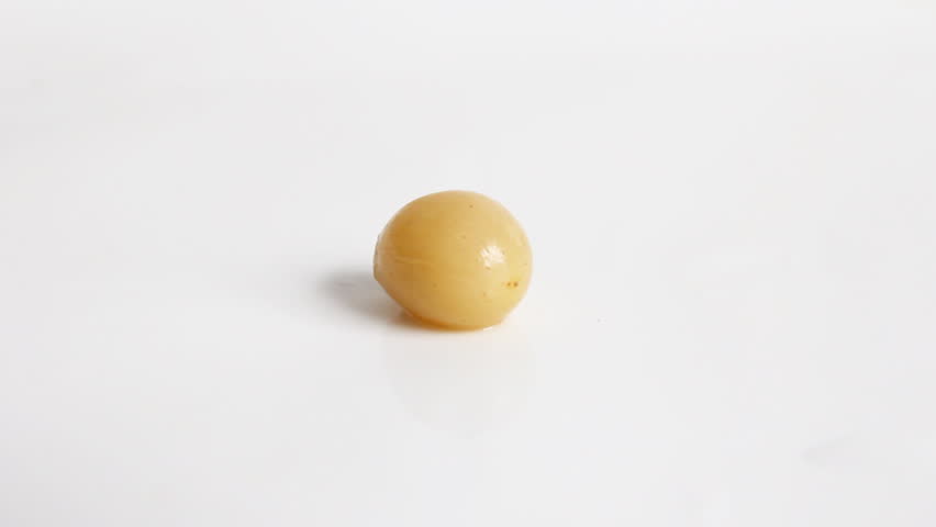 small grape on a white background is cut with a knife