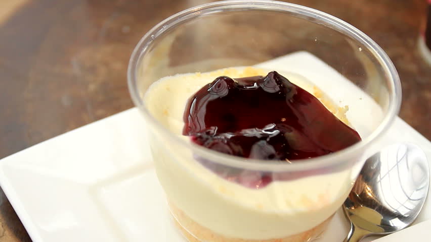 Blueberry crumble cup cake on dish scoop with spoon.