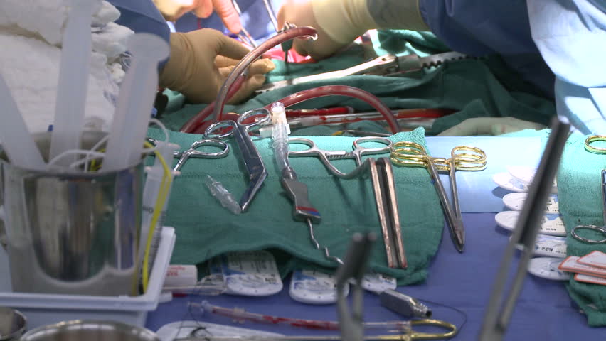 Surgical table with operation in background