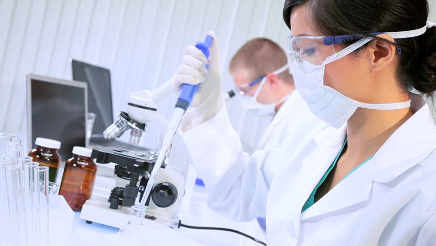 Caucasian and asian chinese doctors working with microscopes and test tubes in laboratory conditions