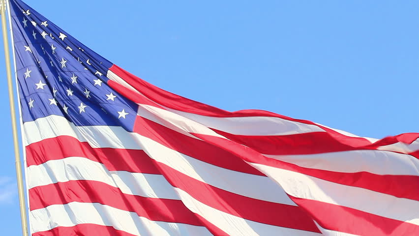 Closeup of jumbo American flag against a blue sky - HD - 1920x1080