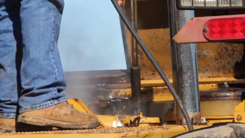 Boots And Jeans Doing Pressure Washing Closeup 