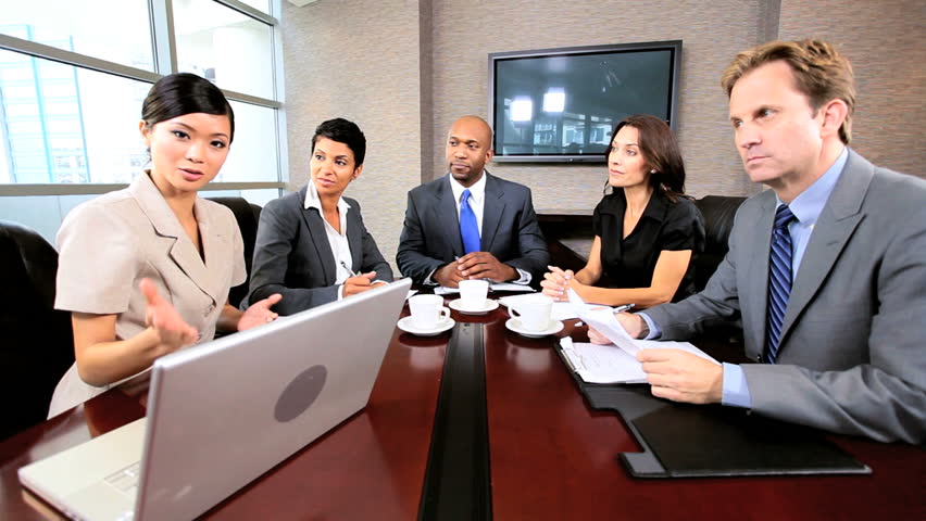 Multi ethnic executive team using a video link for a conference business meeting