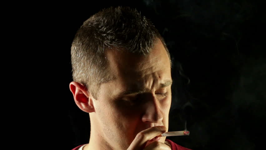 Insane crazy man smoking a cigarette having a nervous breakdown