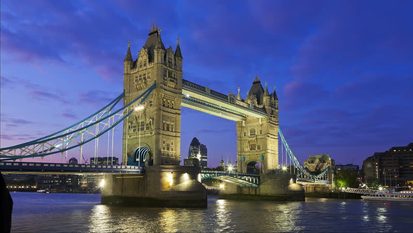 Tower Bridge in London opening for passing underneath boat, London, United Kingdom