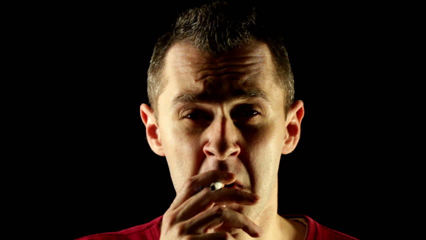 Insane crazy man smoking a cigarette having a nervous breakdown