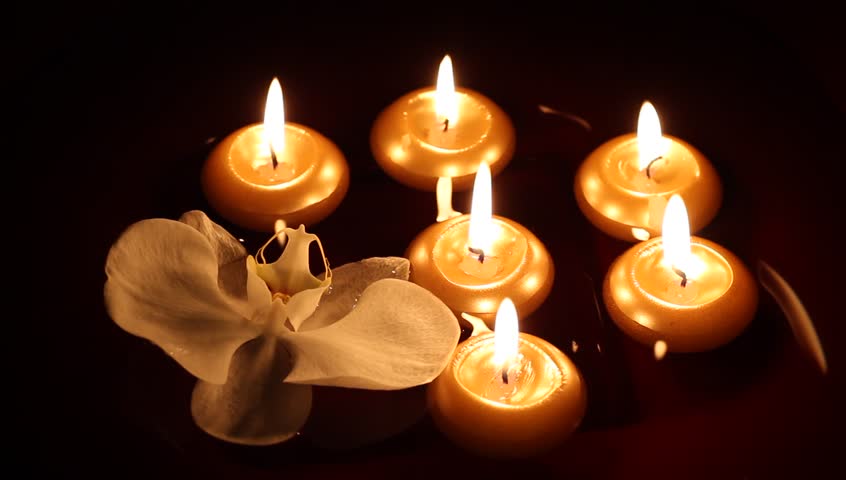 Floating candles and orchid in dark - spa concept