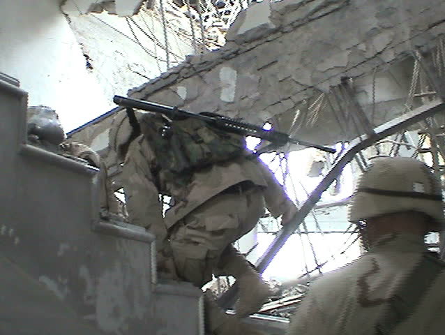BAGHDAD, IRAQ - CIRCA 5/11/03: U.S. Soldiers survey blast damage from Tomahawk and JDAM munitions; Baath Party HQ and other buildings at Abu Ghraib Complex.