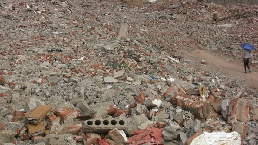 QINGDAO - APRIL 19: Young woman walks through demolished quarter on April 19, 2010 in Qingdao, China.