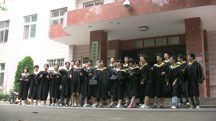 QINGDAO - JUNE 25: Chinese students throw hats in the air after graduation at Qingdao University on June 25, 2010 in Qingdao, China.