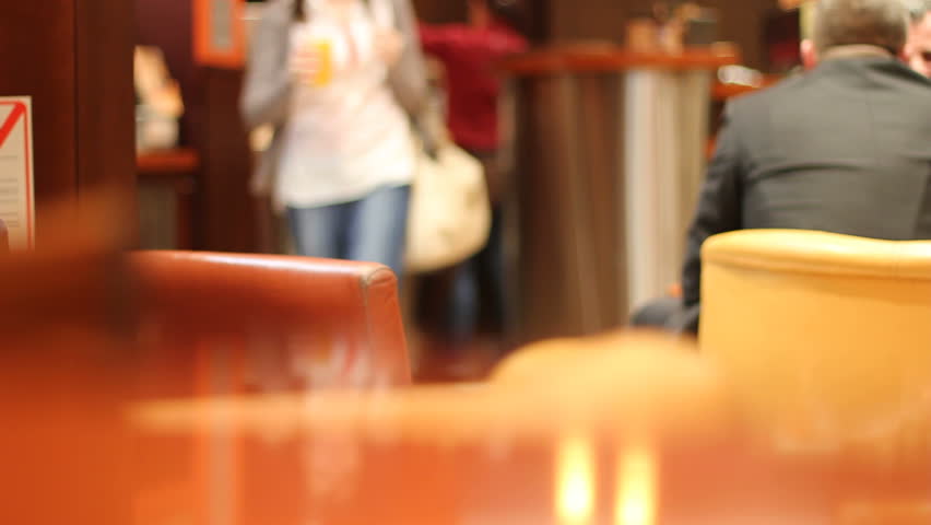 Woman brings juice to the table in a cafe