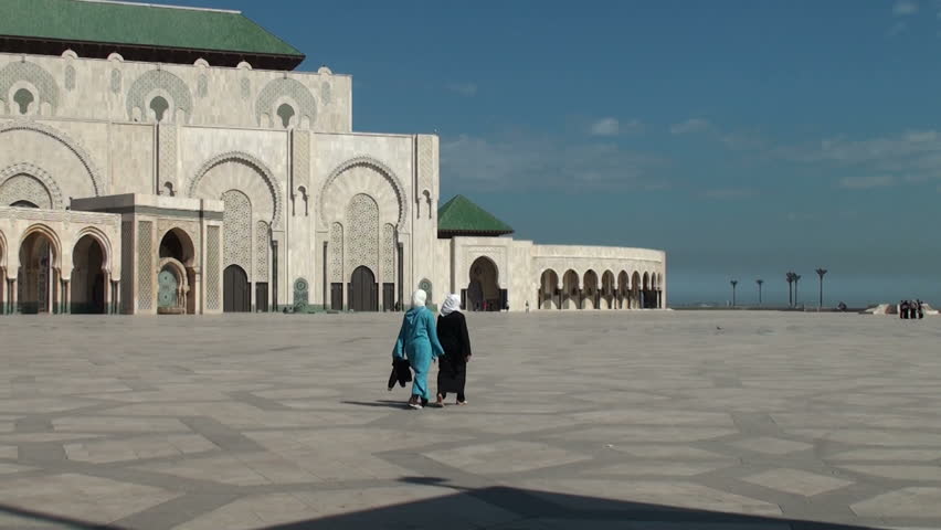 CASABLANCA - MARCH 12: Two Muslim women and two young girls walk on the square of Hassan II Mosque on March 12, 2011 in Casablanca, Morocco.