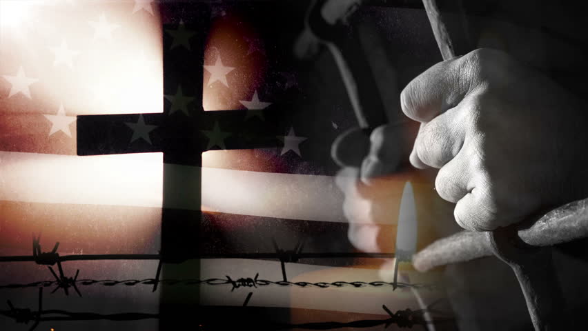 Prisoner in front of waving US flag. Rich patriotic look.