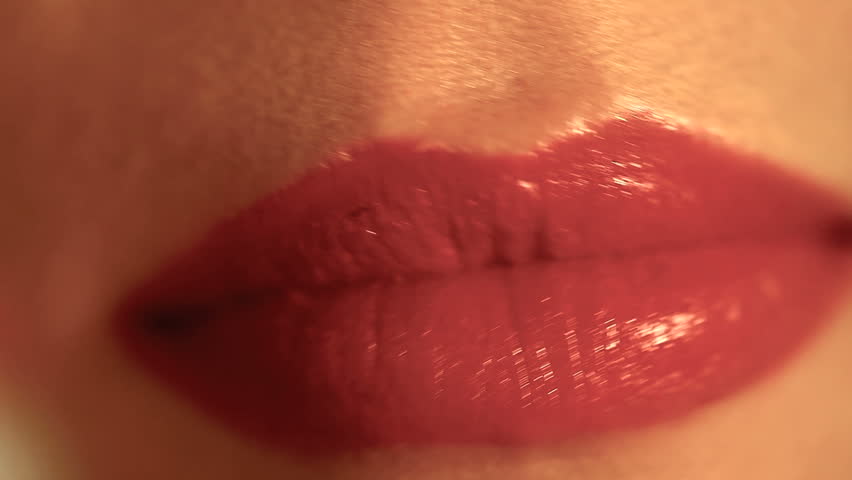 woman applying red lipstick 