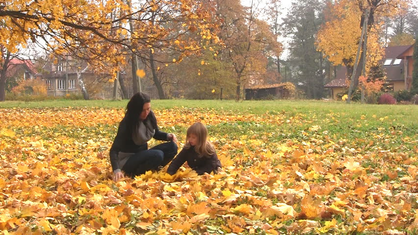Mother and daughter having fun together at autumn
