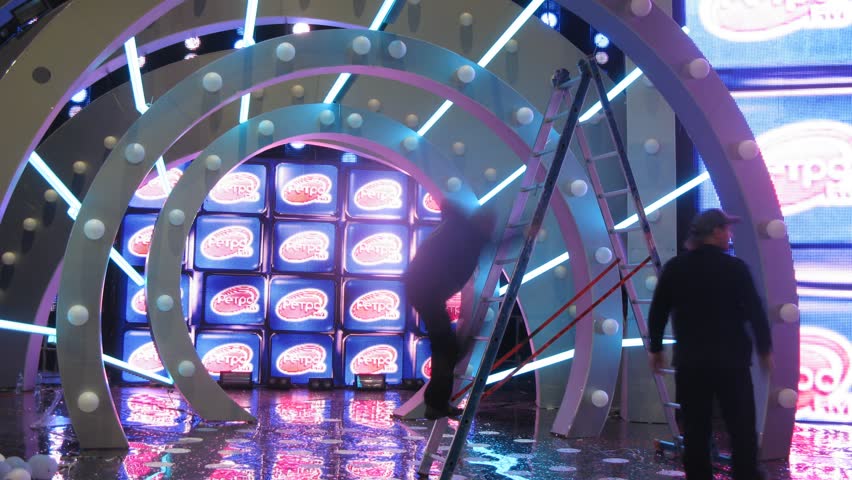 MOSCOW - DEC 17: (Timelapse View) Workers unscrew bulbs in scenery in form of tunnel, concert of Legend RetroFM in Sports complex Olimpiyskiy, on Dec 17, 2011 in Moscow, Russia 