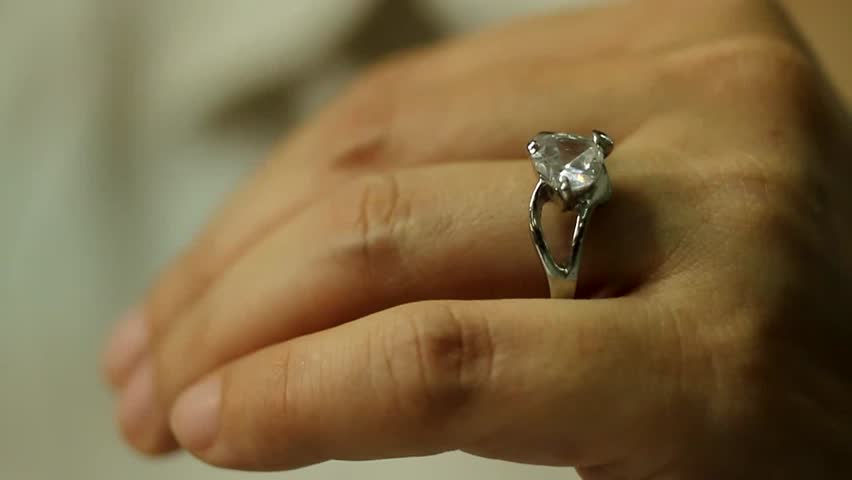 Divorce, a woman hand take off a diamond ring from the finger