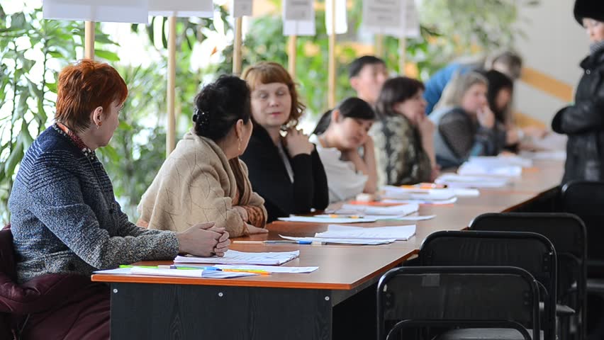ULAN-UDE, RUSSIA - MARCH 4: The divisional election committee 699 of  Burytia Republic register voters at the presidential election of Russian Federation on March 4, 2012 at a local polling station in Ulan-Ude, Buryatia, Russia.