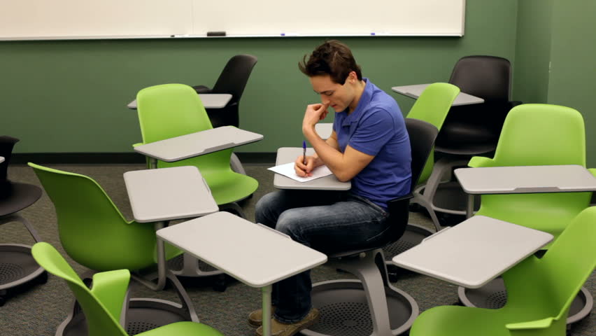 Nervous man surrounded by chairs