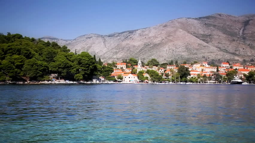 Panorama of small town Cavtat near Dubrovnik. Two jet ski watercraft passing by.