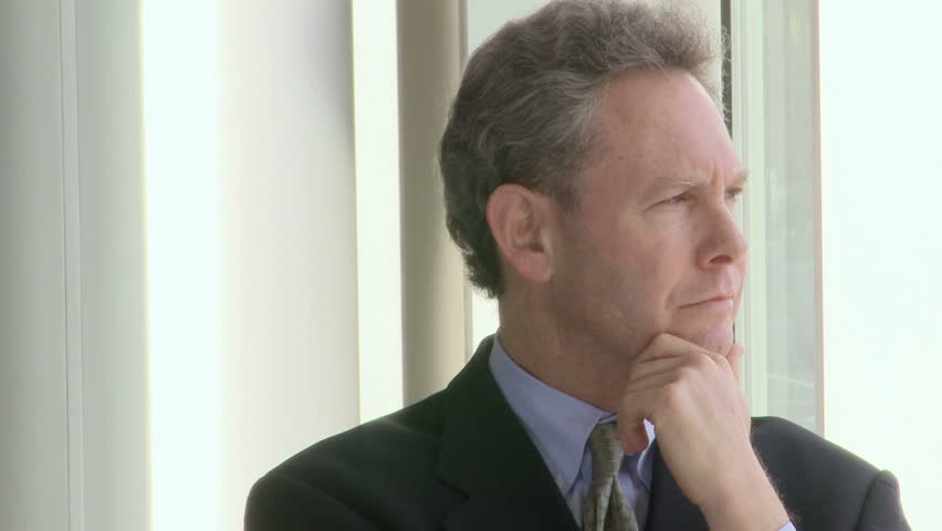 Middle aged man looks at camera and smiles