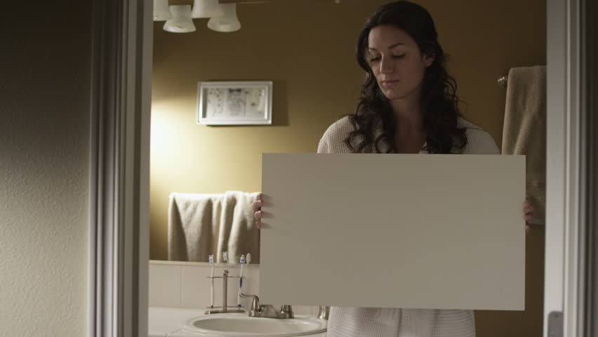 A couple  balancing home life and professional life. Authentic moments around the house are captured as the couple gets ready for the day, completes work on the computer.