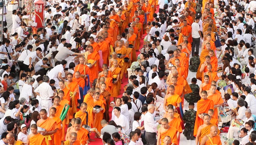 BANGKOK , THAILAND - MARCH 17: People give food offerings to Buddhist monks on March 17, 2012 in Bangkok, Thailand.