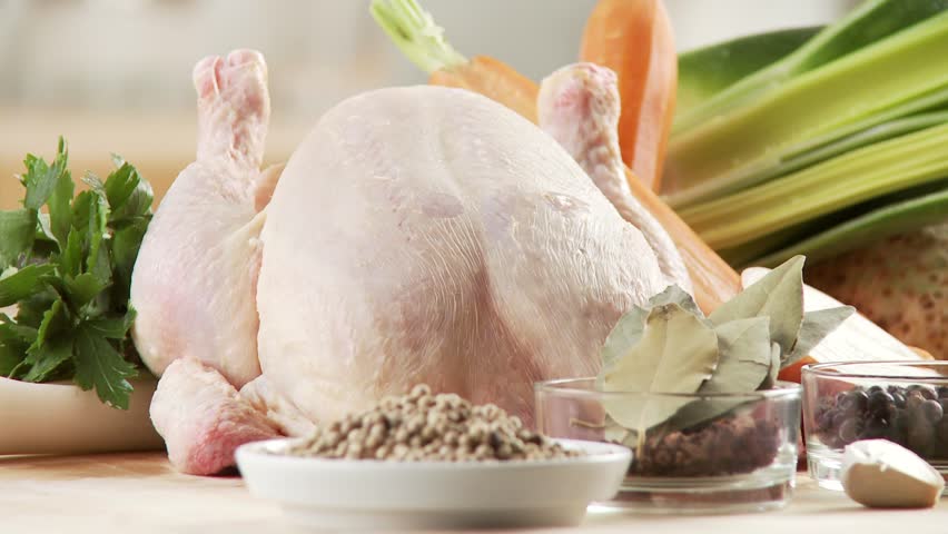 Ingredients for chicken soup: chicken, spices, mirepoix