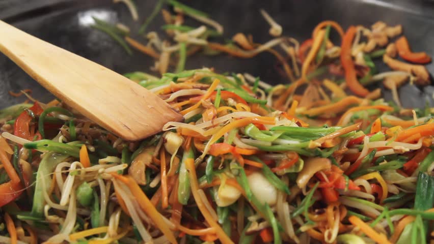 Stir-frying vegetables in a wok