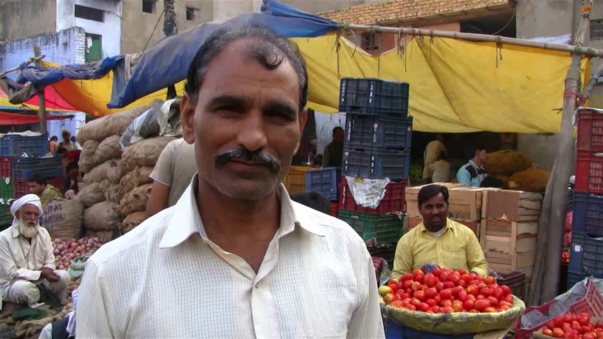 DELHI - NOV 13: Market vendor selling vegetables on a local market on November 13, 2011 in Delhi, India. India ranks second worldwide in farm output. Agriculture employs 52.1% of the total workforce.