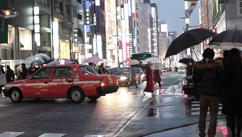 TOKYO - MARCH 18: Pedestrians in the streets of Ginza in Tokyo on March 18, 2012. Even during bad weather Tokyo's most important luxury district attracts shoppers from all over the world.