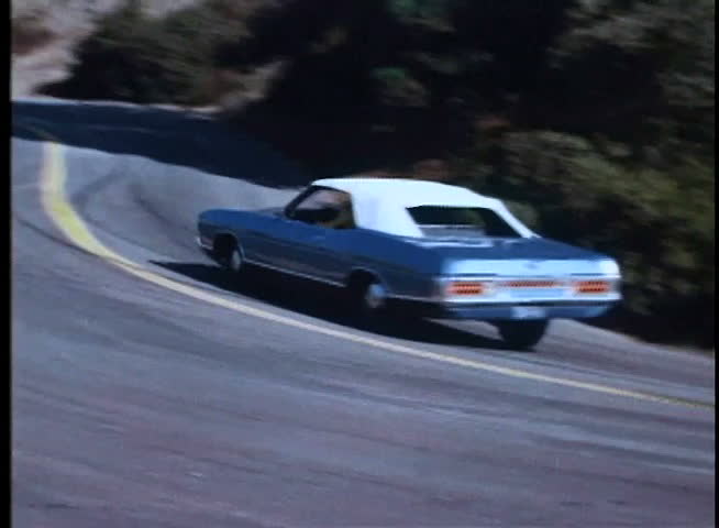 High speed car chase on winding mountain road