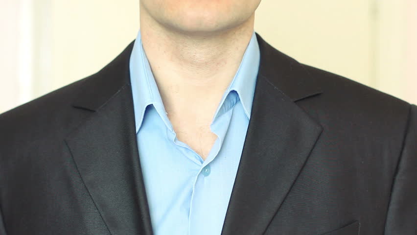 Businessman ties a tie