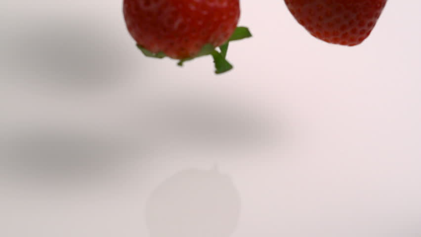 Slo-mo strawberry into milk