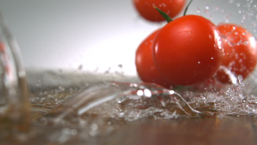 Super close-up ripe tomatoes with water splash