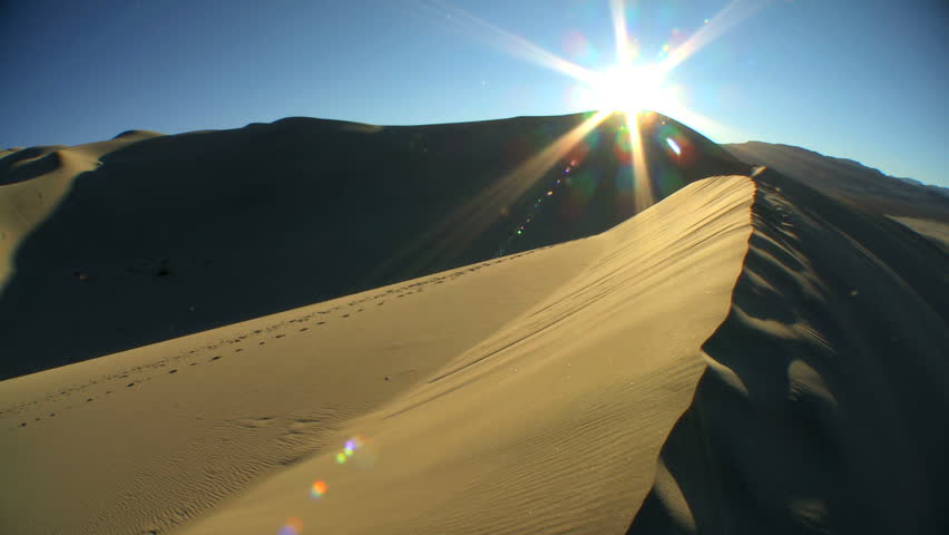 Time lapse of sundown on barren sand dune landscape