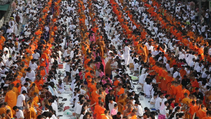 BANGKOK - MARCH 25: Monks are participating in a Mass Alms Giving of 12,600 monks in Central World for the Makha Bucha celebrations on March 25, 2012 in Bangkok, Thailand.