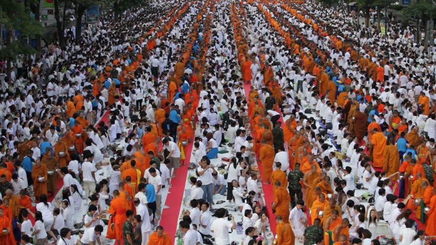 BANGKOK - MARCH 25: Monks are participating in a Mass Alms Giving of 12,600 monks in Central World for the Makha Bucha celebrations on March 25, 2012 in Bangkok, Thailand.