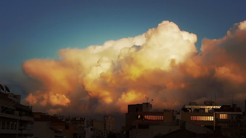 Timelapse of a huge storm cloud formation over a city skyline