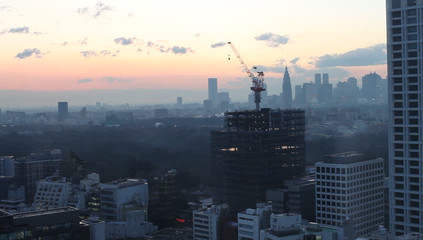 Aerial view of high-rise office buildings and residential area in downtown Tokyo, Japan during sunset
